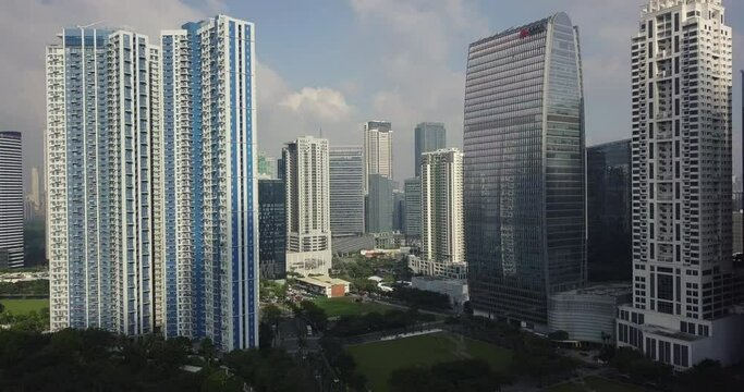 Zoom out aerial flight to reveal high rise building's area. Business district. Urban landscape view. Drone, 4K.