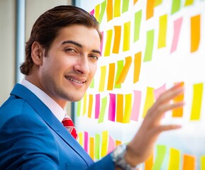 Young handsome employee with many conflicting priorities
