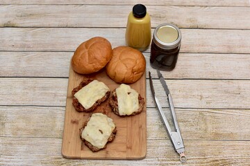 Father's Day barbecue with grilled cheeseburgers and fresh homemade condiments to celebrate family with outdoor cooking at a picnic