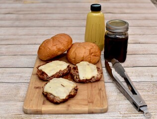 Father's Day barbecue with grilled cheeseburgers and fresh homemade condiments to celebrate family with outdoor cooking at a picnic