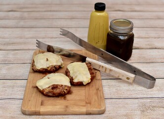 Father's Day barbecue with grilled cheeseburgers and fresh homemade condiments to celebrate family with outdoor cooking at a picnic