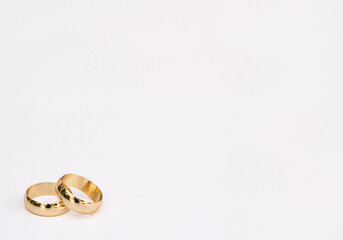 two golden wedding rings isolated on white background. Wedding background