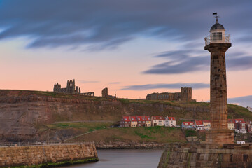 Golden Hour skies over Whitby Abbey and the pier at Whitby Bay