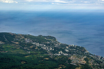 Fototapeta na wymiar Summer aerial view on the city by the sea coast with horizont