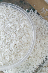 Raw white rice on the table, wood background