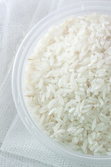 Raw white rice in bowl, close up top view food