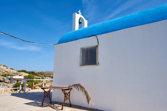 Traditional white greek church with blue dome in Kolymbia harbor on Rhodes island. Greece