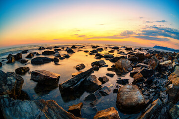 Fototapeta na wymiar Beautiful seascape. Sunset and the sea natural landscape with stones. Fisheye lens