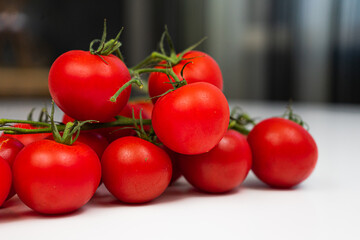 Cherry tomatoes on a branch close-up white background