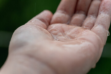 Palm hands with water splash. Nature raindrop, environmental and freshness concept.
