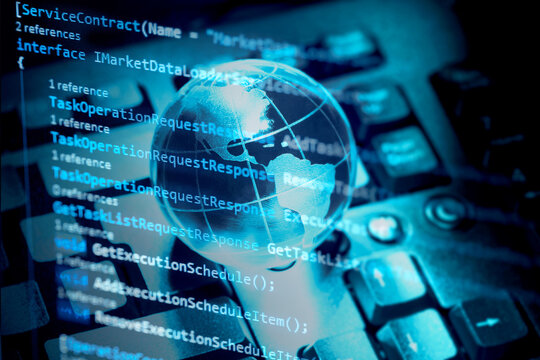 Programming code, world transparent globe earth on computer keyboard. Global communications business concept. Blue toned.