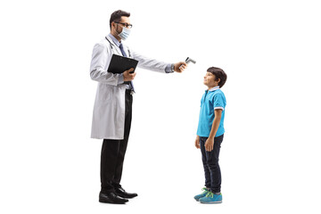 Male doctor measuring a temperature to a boy