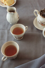 Two cup of tea with teapot, on gray background. Antique cup and teapot, 