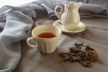 cup of tea and teapot on gray background. antique cup and teapot