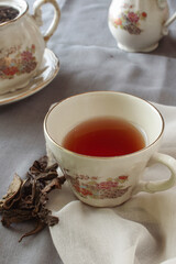 cup of tea and teapot on gray background. antique cup and teapot