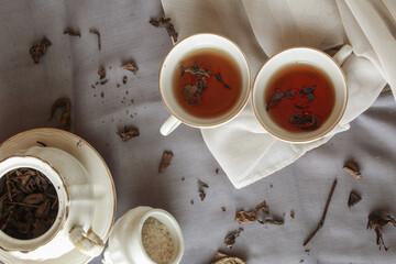 Two cup of tea with teapot, on gray background. Antique cup and teapot, 