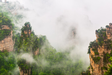 Zhangjiajie National park. Famous tourist attraction in Wulingyuan, Hunan, China. Amazing natural landscape with stone pillars quartz mountains in fog and clouds