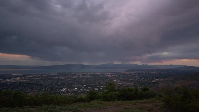 Time lapse at dawn from viewpoint over Utah Valley as the sun lights the clouds during sunrise.