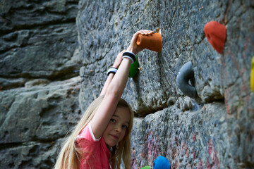 Child Girl having fun during rock climbing training on boulder wall © Petr Bonek