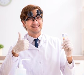 Chemist in the lab checking with ph strips
