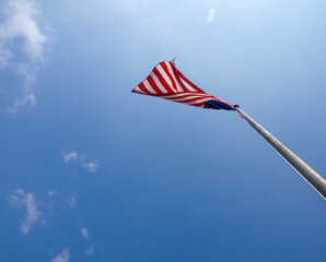 American flag on pole against blue sky