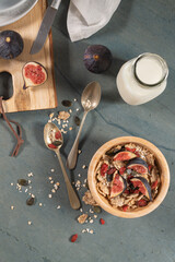 Granola for healthy breakfast. Bowl with granola , milk , fresh fig and dried berries