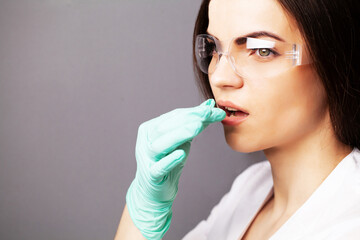 Sexual health, a doctor in a white coat holding a pill for a healthy sex life of men