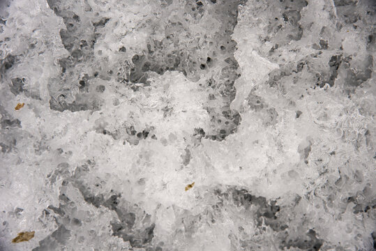 Amazing view of close up ice when it is melting in the spring time. An abstract photo background of thawing winter. 