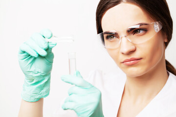 Female doctor in laboratory holding holding test tubes with experimental antiviral vaccine