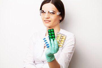 Sexual health, a doctor in a white coat holding a pill for a healthy sex life of men