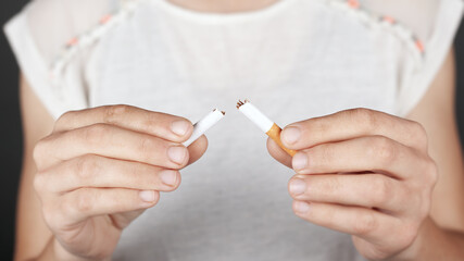 concept health, no smoking, bad habit. girl holds a broken cigarette in her hands close-up