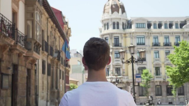 young tourist in a medical protective black mask visits the sights on a trip to Europe and Spain. Travel concept after coronavirus epidemic. Opening borders and the beginning of the tourist season