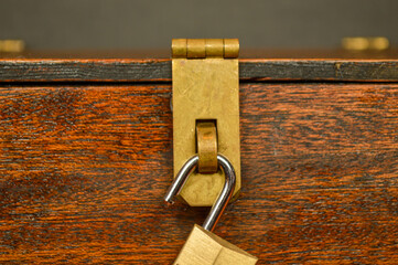 Open lock on a wooden box with a brass latch