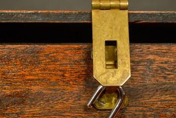 Open lock on a wooden box with a brass latch