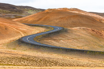 Main road of S-curved shape in active volcanic area near Myvatn lake, Iceland - 354187575