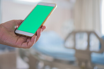 Health care technology concept, Blank Green Screen Mock up smartphone for Text advertising, Hospital Patients woman senior using smart phone while Recovering moment
