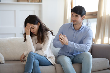 Desperate young man ask forgiveness make peace with offended annoyed mad wife, caucasian husband...
