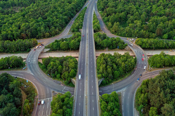 Wide motorway roundabaout exit on each corner along straight road