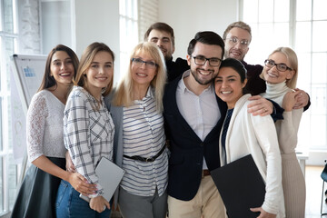 Portrait of emotional positive bonding diverse business people, posing for photo in office....