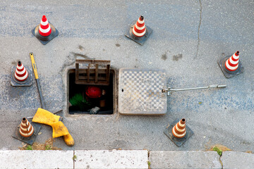 sequence of worker going in the manhole in the street, step 4