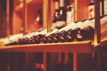 bottles of wine in wine bar or wine shop for soft background - obrazy, fototapety, plakaty