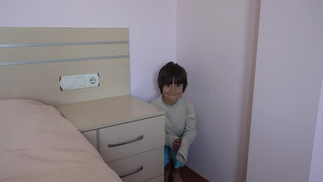 4K Naughty boy being put in the corner is smiling, crystal child
