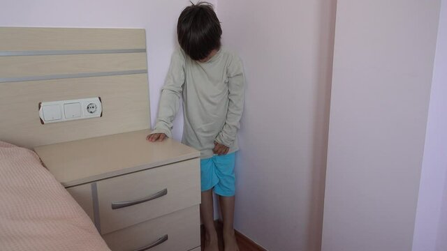 4K Poorly punished child standing in the corner
