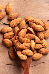 Top view  peeled almond in wood spoon wood table almond Nuts Ready to use with advertising text