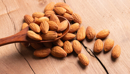 side view Select focus  peeled almond in wood spoon wood table almond Nuts Ready to use with advertising text
