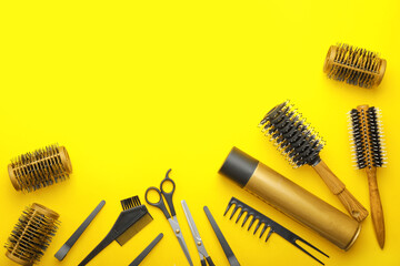 Hair spray with hairdresser supplies on color background