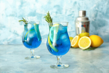 Glasses of healthy cocktail on color background