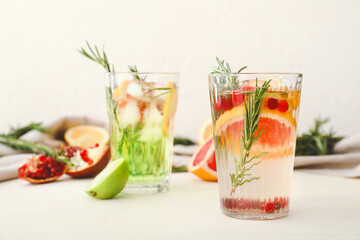 Glasses of healthy cocktail on white background