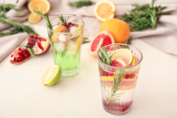 Glasses of healthy cocktail on white background