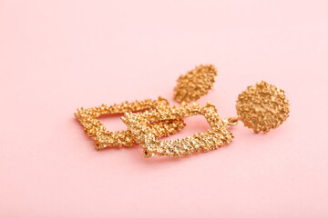 Beautiful earrings on color background